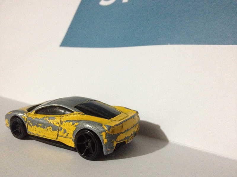 Illustration for article titled Presenting: the most beat-up (but still butt-kicking) 1:64 Ferrari 458 ever